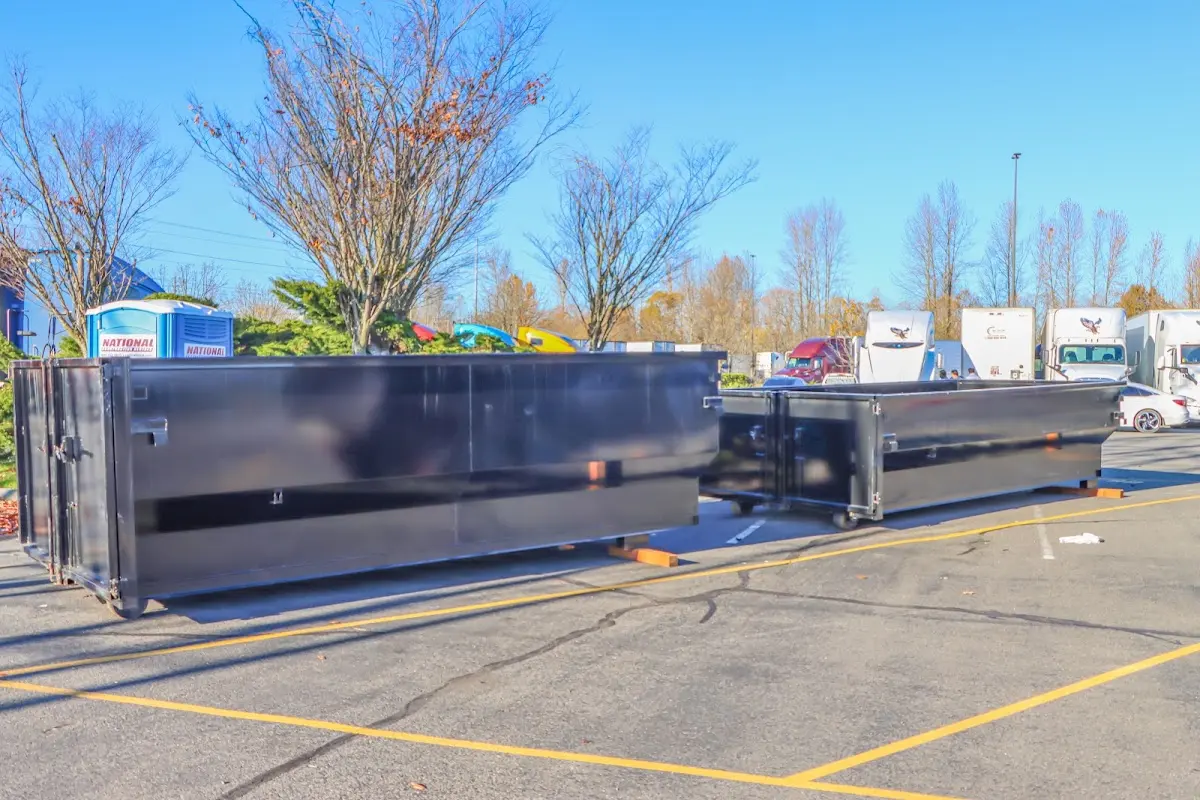 Professional dumpster rental service with roll-off container on residential driveway in Chickasha